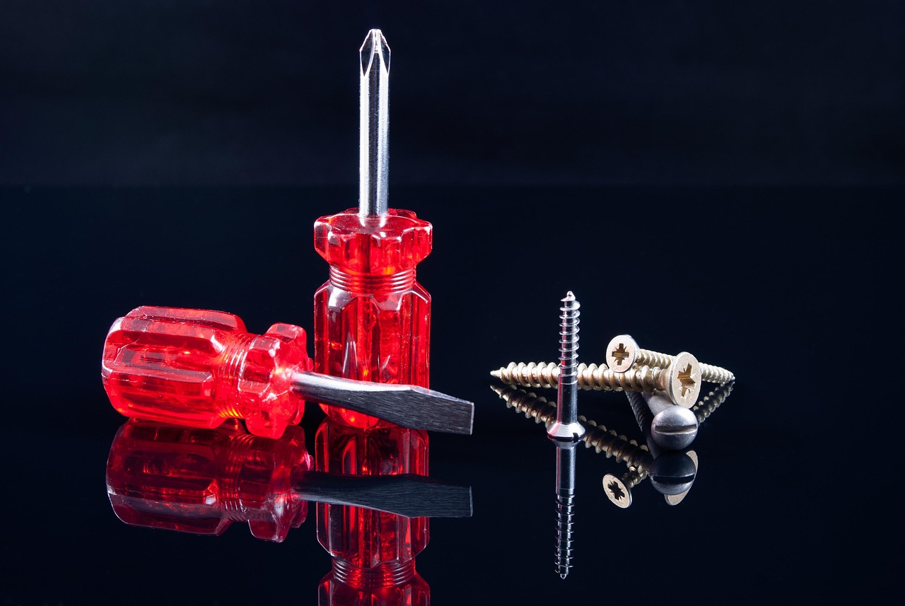 Screwdrivers and fixings arranged on a workbench — the tools of careful carpentry and joinery